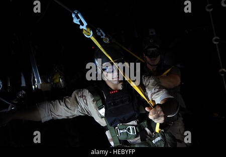 Pararescumen from the 82nd Expeditionary Rescue Squadron, Moody Air Force Base, Ga. prepare to jump from a HC-130 from the 71st Search and Rescue Squadron, Moody AFB, Ga. during a training jump on March 13, 2008 while deployed to the Combined Joint Task Force- Horn of Africa located at Camp Lemonier, Djibouti. The Pararescue mission comprised of dropping a Rigging Alternate Method Zodiac (RAMZ) out the back of the HC-130 over the Gulf of Aden at 1500 feet followed by a three man static jump, then climbing to 3500 feet for a three man high altitude low opening jump. (U.S. Air Force photo/Tech.  Stock Photo