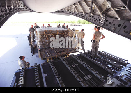 As part of the cargo shipments from Transit Center at Manas, Airmen stack empty surplus pallets on a C-17 Globemaster III, May 20, 2014.  Technical Sgt. Edgardo Franco, air transportation craftsman, Senior Master Sgt. Shawn Walker, superintendent of knowledge operations,  Col. John Vaughn, 376th Air Expeditionary Wing vice commnader, Chief Master Sgt. Gregory Warren, 376th AEW command chief, Senior Airman Kody Novak, air transportation journeyman, Staff Sgt. Jon Luna, air transportation craftsman, Staff Sgt. Lucas Hofstra, air transportation craftsman, Senior Master Sgt. Mark Foreman, Air Term Stock Photo