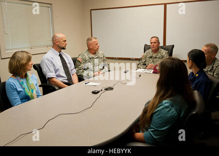 U.S. Army Brig. Gen. Dennis Doyle, Pacific Regional Medical Command and TAMC Commanding General, and PRMC subject matter experts participate in a Video-Teleconference demo to test its effectiveness in delivering Tele-Behavioral health care to Guam Army National Guardsman May 13, 2014, at Tripler Army Medical Center, Hawaii. The VTC system will benefit returning deployers by providing Soldiers in Guam treatment while cutting the costs of travel. The system is slated to be available in June 2014.(U.S. Air Force photo by Staff Sgt. Christopher Hubenthal) Stock Photo