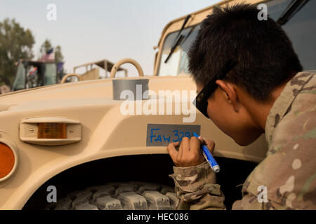 Senior Airman Leah Johnson, 19th Movement Control Team aerial porter, prepares a vehicle for shipping at Forward Operating Base Salerno, Khost province, Afghanistan, Sept. 22, 2013. The 19th MCT, a small squadron of Air Force surface movement controllers and aerial porters, have the herculean task of overseeing the vast majority of retrograde operations at FOB Salerno. Johnson, a St. Paul, Minn. native, is deployed from Travis Air Force Base, Calif. (USAF Photo/Master Sgt. Ben Bloker) Stock Photo