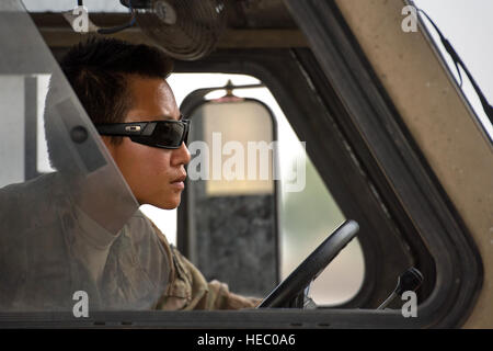 Senior Airman Leah Johnson, 19th Movement Control Team aerial porter, manipulates a K-loader into position to transfer pallets to a C-130 Hercules cargo plane at Forward Operating Base Salerno, Khost province, Afghanistan, Sept. 22, 2013. The 19th MCT, a small squadron of Air Force surface movement controllers and aerial porters, have the herculean task of overseeing the vast majority of retrograde operations at FOB Salerno. Johnson, a St. Paul, Minn. native, is deployed from Travis Air Force Base, Calif. (USAF Photo/Master Sgt. Ben Bloker) Stock Photo