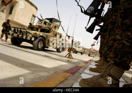 Iraqi soldiers stand at attention during the departure of the official party following the turnover ceremony of Multi-National Force - Iraq, Combat Outpost Power in the Aden District of Mosul, Iraq, June 7. The 3rd Battalion, 12th Brigade, 2nd Iraqi Army Division assumes command and control of COP Power from the U.S. Army, Alpha Battery, 3rd Battalion, 82nd Field Artillery Regiment, 3rd Greywolf Heavy Brigade Combat Team, 1st Cavalry Division. Stock Photo
