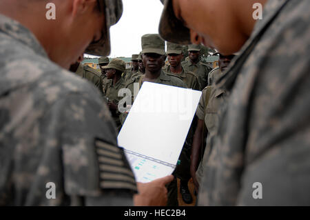 Uganda Army soldiers stand in formation before being released to begin their land navigation course taught to them by U.S. Army Soldiers from 3rd Platoon, Delta Company, 1st Battalion, 3rd Infantry Regiment, The Old Guard, Fort Myers, Virginia, on February 12, 2008 at Forward Operating Location Kasenyi, Uganda. The Ugandan Soldiers are given a compass and a map and are then expected to go out and find five markers in the field. Soldiers from The Old Guard are tasked with training the Ugandan Soldiers during a 16 week Military to Military training school located at Forward Operating Location Ka Stock Photo