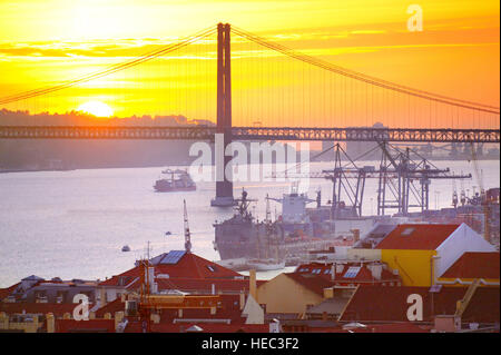 View of Lisbon port and 25 April bridge at sunset. Portugal Stock Photo