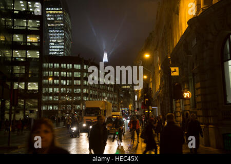 London’s tallest skyscraper, the Shard, beams out spotlights in the distance in the City of London as part of a light show creating a public art installation in the sky on 13th December 2016 in London, England, United Kingdom. Stock Photo