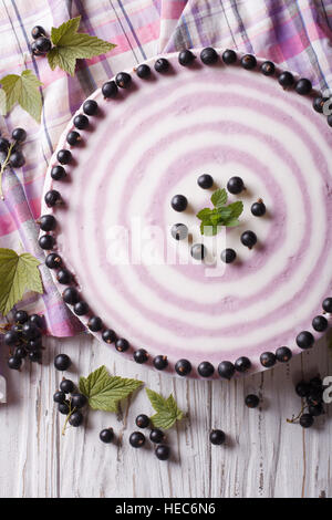 Delicious cheesecake striped black currant close up on the table. vertical top view Stock Photo