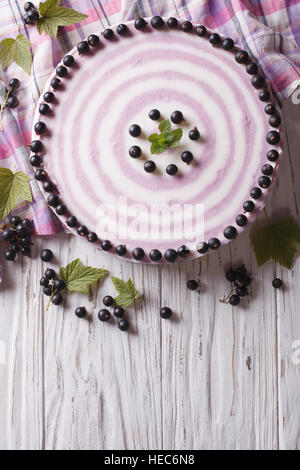 Delicious cheesecake striped black currant on the table. vertical top view Stock Photo