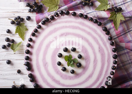 Delicious cheesecake striped black currant close up on the table. horizontal top view Stock Photo