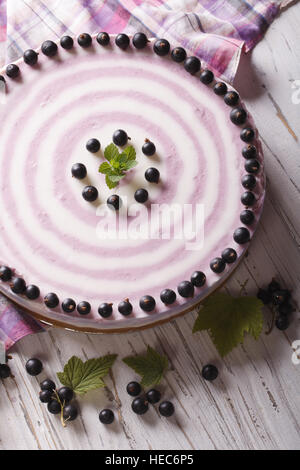 Round striped currant cheesecake close-up on the table. vertical top view Stock Photo