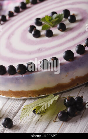 Beautiful striped currant cheesecake close-up on a plate. Vertical Stock Photo