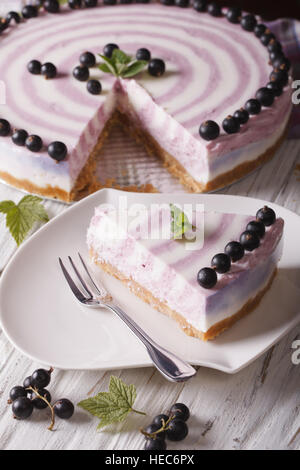 Beautiful currant cheesecake chopped close-up on a plate. vertical Stock Photo