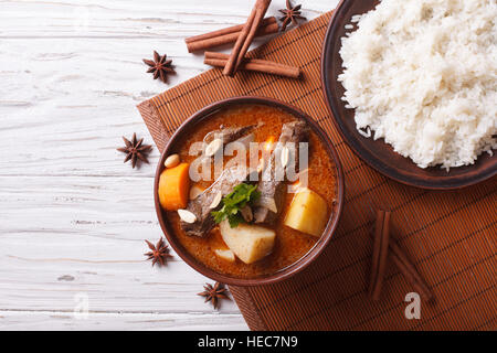 Hot traditional Thai beef massaman curry with peanuts and rice side dish. horizontal view from above Stock Photo