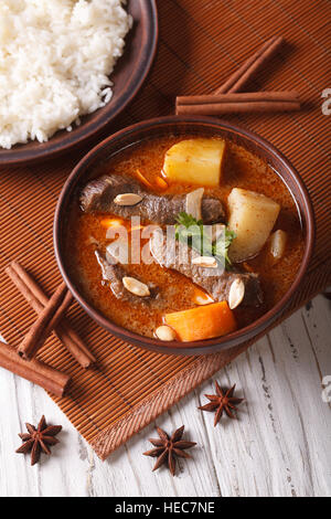 traditional Thai beef massaman curry with peanuts close-up. vertical top view Stock Photo