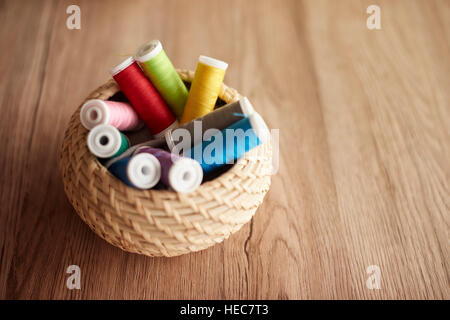 Colorful thread spools in the basket Stock Photo
