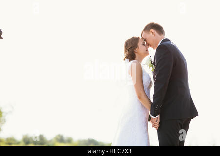 couple bride and groom on field background. Stock Photo