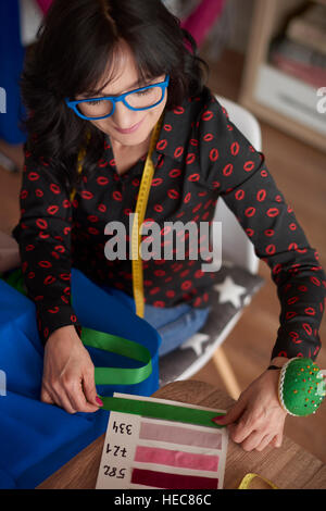 Woman using a fabric pattern board Stock Photo