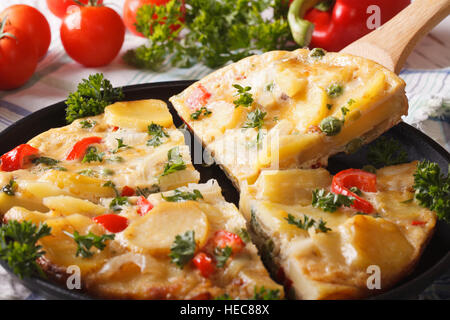 sliced traditional Spanish omelette with fried potatoes. Horizontal close-up Stock Photo