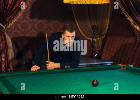 handsome serious man playing pool Stock Photo