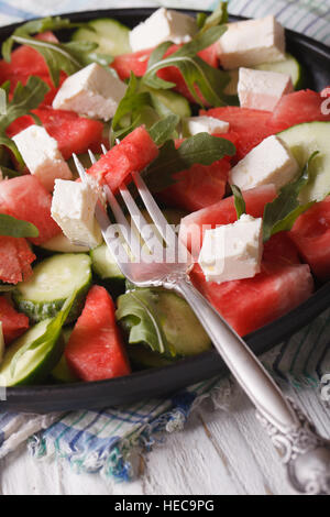 salad of watermelon, feta, arugula and cucumber closeup on a table. vertical Stock Photo