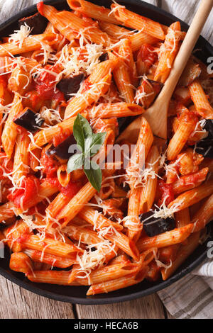 Pasta alla Norma. Penne with eggplant and tomatoes close-up. Vertical Stock Photo