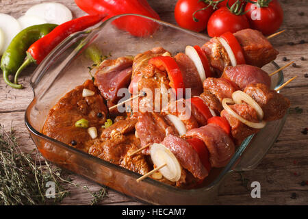 Raw kebab with vegetables in a spicy marinade on the skewers closeup horizontal Stock Photo