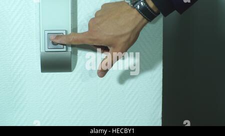 businessman presses the Elevator button, close-up Stock Photo