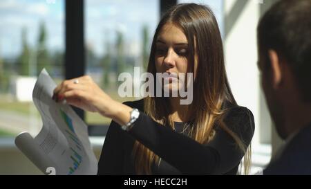businesswoman showing graph to his colleague Stock Photo