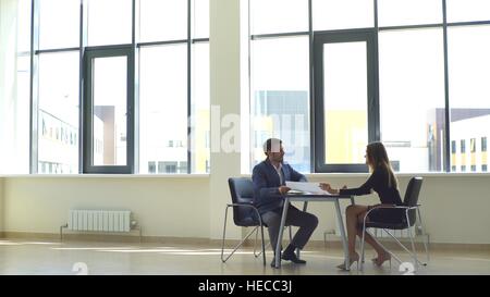 a successful businessman discusses graphics businesswoman Stock Photo