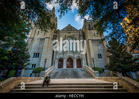 Man sitting on the steps of First United Methodist Church, in Uptown Charlotte, North Carolina. Stock Photo