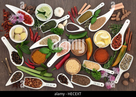Spice and herb sampler with fresh and dried herbs and spices on oak background. High in antioxidants and vitamins. Stock Photo