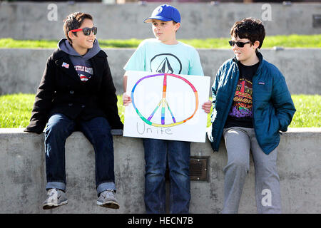 Napa, CA, USA. 19th Dec, 2016. From left, Kai Gulliksen, 10, Zack Simi, 11, and Jed Rubin, 12, wait in Veterans Memorial Park in downtown Napa on Monday, for a protest and march to begin. The group Rise Up, Napa organized the event to urge electors not to cast their ballots for President-elect Donald Trump and to stand up against hate, discrimination and intolerance. About 70 people attended the protest and march. © Napa Valley Register/ZUMA Wire/Alamy Live News Stock Photo
