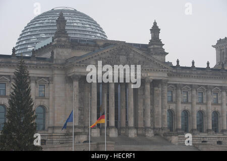 Berlin, Germany. 20th Dec, 2016. Flags fly at half mast outside the Reichstag in Berlin, Germany, 20 December 2016. According to police, at least 12 people have been reportedly killed and at least 48 injured when a lorry rammed into a local Christmas market in the evening of 19 December 2016. German police suspect the incident may have been a deliberate attack. Photo: Paul Zinken/dpa/Alamy Live News Stock Photo