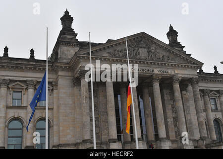 Berlin, Germany. 20th Dec, 2016. Flags fly at half mast outside the Reichstag in Berlin, Germany, 20 December 2016. According to police, at least 12 people have been reportedly killed and at least 48 injured when a lorry rammed into a local Christmas market in the evening of 19 December 2016. German police suspect the incident may have been a deliberate attack. Photo: Paul Zinken/dpa/Alamy Live News Stock Photo