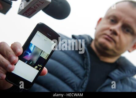 Sobiemysl, Poland. 20th Dec, 2016. The Polish owner of a freighting company Ariel Zurawski shows journalists a picture of his cousin in Sobiemysl, Poland, 20 December 2016. The photo was supposedly taken only hours before the death of his cousin, a truck driver whom police think may have been adbucted along with the truck used by an unknown assailant in a suspected terror attack on a busy Christmas market in Berlin on Monday evening (19.12.16). Credit: dpa picture alliance/Alamy Live News Stock Photo