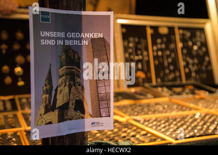 Essen, North Rhine-Westphalia, Germany. 20th Dec, 2016. Stall holders displayed signs 'our thoughts are in Berlin'. After the terrorist attack on the Berlin Christmas Market on 19th December, many customers stayed away from the traditional Christmas Market in the town centre of Essen. A large police presence made sure that shoppers were safe. © Bettina Strenske/Alamy Live News Stock Photo