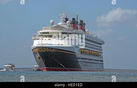 The Disney Wonder is a cruise ship operated by Disney Cruise Line, which carries 2,400 passengers and 945 crew, in the harbor of George Town, Grand Cayman in the Cayman Islands on Tuesday, December 20, 2016.  The smaller boats are tenders to ferry passengers back and forth to the island. Credit: Ron Sachs / CNP /MediaPunch Stock Photo