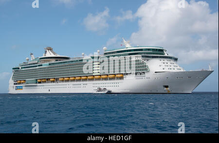 The Royal Caribbean Freedom of the Seas, which carries 4,515 passengers and 1,360 crew, and the Celebrity Reflection, which carries 3,609 passengers and 1271 crew, in the harbor of George Town, Grand Cayman in the Cayman Islands on Tuesday, December 20, 2016.  The smaller boat is a tender to ferry passengers back and forth to the island. Credit: Ron Sachs / CNP /MediaPunch Stock Photo