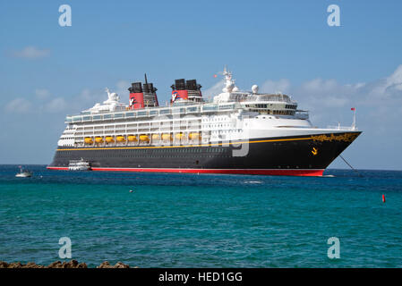 The Disney Wonder is a cruise ship operated by Disney Cruise Line, which carries 2,400 passengers and 945 crew, in the harbor of George Town, Grand Cayman in the Cayman Islands on Tuesday, December 20, 2016.  The smaller boats are tenders to ferry passengers back and forth to the island. Credit: Ron Sachs / CNP /MediaPunch Stock Photo