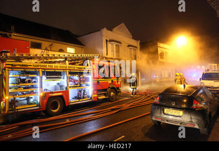 Southsea, Hampshire, UK. 21 December 2016. Fifty Firefighters have been called to tackle a Southsea dry cleaners this morning Ten appliances were called to the Impress launderette in Albert Road just before 6am this morning, Crews from Cosham, Southsea, Fareham, Waterlooville, Portchester and Havant have attended the incident near the Bold Forester Pub. An aerial ladder from St Mary's was brought in to tackle the blaze from above. The blaze took hold of the Impress dry cleaners, next door to the Bold Forester pub in Albert Road, at approximately 6am this morning. Credit: uknip/Alamy Live News Stock Photo