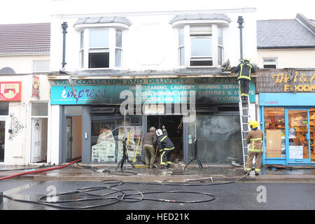 Southsea, Hampshire, UK. 21 December 2016. Fifty Firefighters have been called to tackle a Southsea dry cleaners this morning Ten appliances were called to the Impress launderette in Albert Road just before 6am this morning, Crews from Cosham, Southsea, Fareham, Waterlooville, Portchester and Havant have attended the incident near the Bold Forester Pub. An aerial ladder from St Mary's was brought in to tackle the blaze from above. The blaze took hold of the Impress dry cleaners, next door to the Bold Forester pub in Albert Road, at approximately 6am this morning. Credit: uknip/Alamy Live News Stock Photo