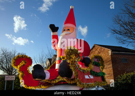 Hoylake, The Wirral, UK.  21st December, 2016. Merry Christmas, Happy Holiday inflatable Santa and a Reindeer with red nose, greet visitors to the town as part of the festive celebrations. Credit: MediaWorldImages/Alamy Live News Stock Photo