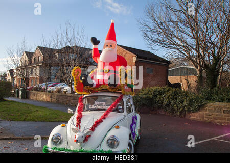 Hoylake, The Wirral, UK.  21st December, 2016. Merry Christmas, Happy Holiday inflatable Santa and a Reindeer with red nose, greet visitors to the town as part of the festive celebrations. Credit: MediaWorldImages/Alamy Live News Stock Photo