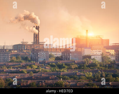 Metallurgy plant at sunset. Steel mill. Heavy industry factory. Steel factory with smog. Pipes with smoke. Metallurgical plant Stock Photo
