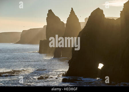 Thirle Door and the Stacks of Duncansby, Caithness, Scotland.  Silhouetted on a winters afternoon. Stock Photo