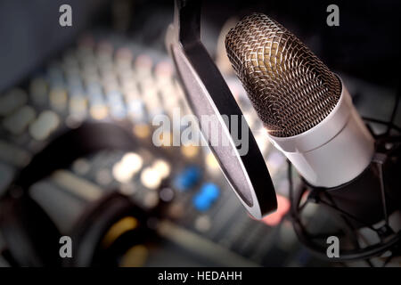 Recording equipment in studio. Studio microphone with headphones and mixer background. Elevated view Stock Photo