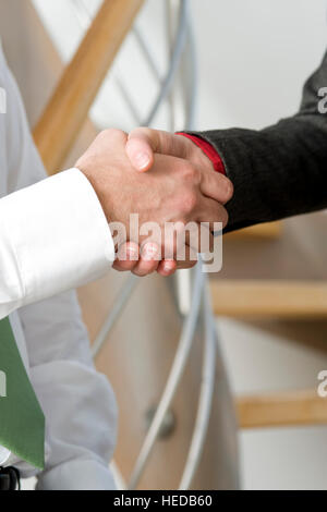 Handshake between business people, businesspeople shaking hands Stock Photo