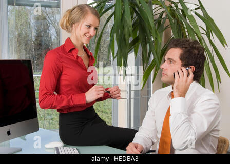 Businessman in his office, flirting with a secretary Stock Photo