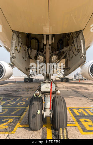 Aircraft undercarriage.  View of a large commercial aircraft from just in front of the nose landing wheel Stock Photo