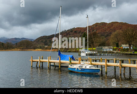 Waterhead on the shore of Lake Windermere, near Ambleside, showing jetties and boats moored up, in the Lake District Stock Photo