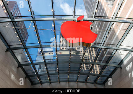 Big Apple logo inside the Apple Store on Broadway and West 67th street is illuminated red. Stock Photo
